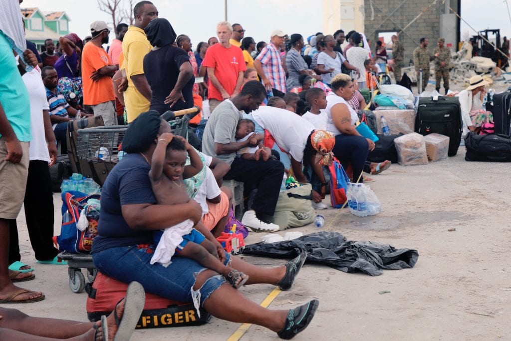 People wait in Marsh Harbour Port to be evacuated to Nassau, in Abaco, Bahamas, Friday, Sept. 6, 2019. The evacuation is slow and there is frustration for some who said they had nowhere to go after the Hurricane Dorian splintered whole neighborhoods. (AP Photo/Gonzalo Gaudenzi)